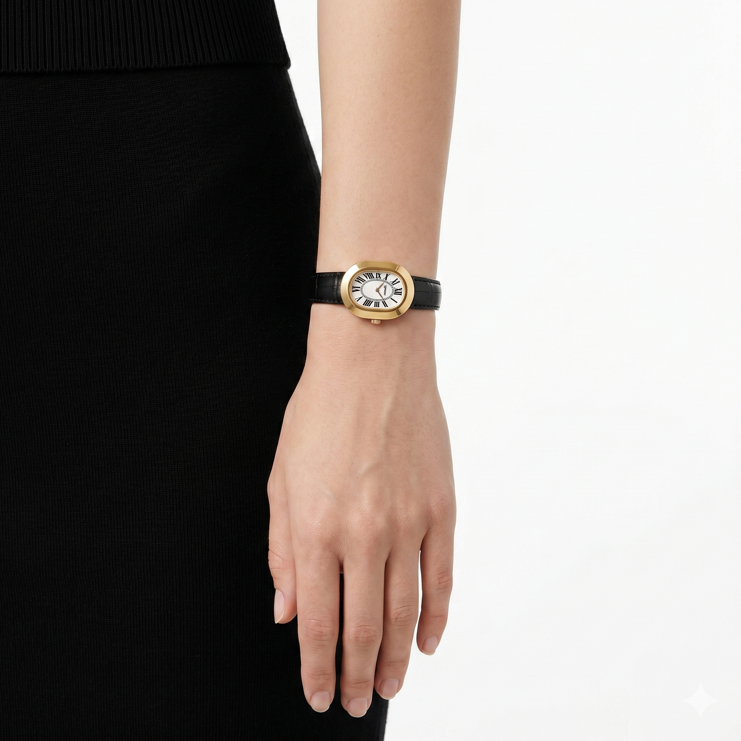 Oule oval gold dress watch with white Roman-numeral dial on black leather strap on wrist